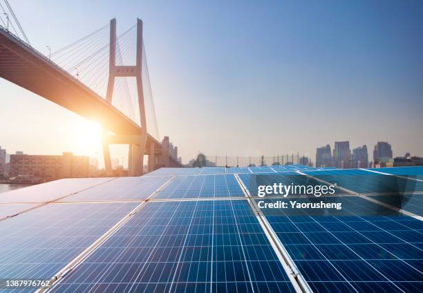 solar panel in front of modern city bridge in the sunset - light burst abstract centre stock-fotos und bilder