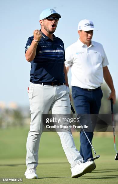 Ewen Ferguson of Scotland celebrates his birdie putt on the 18th green during the final round of the Commercial Bank Qatar Masters at Doha Golf Club...