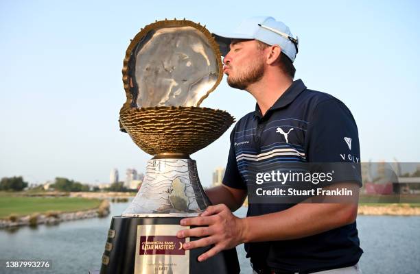 Ewen Ferguson of Scotland celebrates with the winners trophy after the final round of the Commercial Bank Qatar Masters at Doha Golf Club on March...