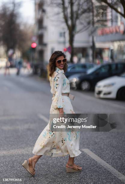 Anna Wolfers wearing beige shades, a beige maxi dress with floral pattern, a beige belt and beige heels via goldigshop.de on March 25, 2022 in...