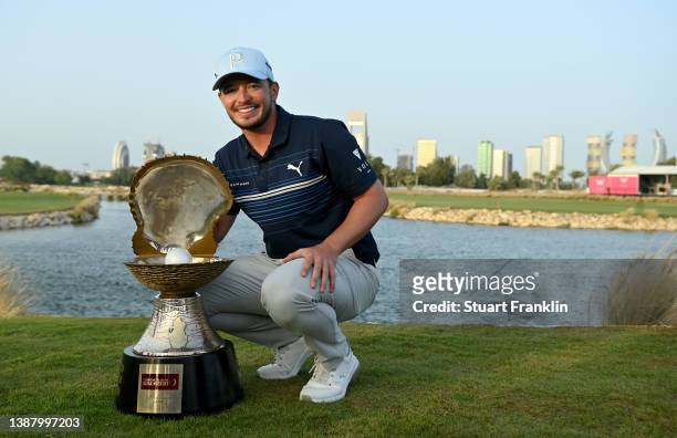 Ewen Ferguson of Scotland celebrates with the winners trophy after the final round of the Commercial Bank Qatar Masters at Doha Golf Club on March...