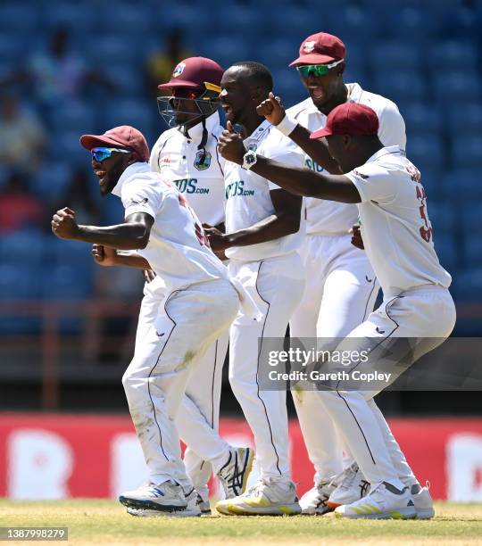 Kemar Roach of the West Indies celebrates with teammates after dismissing Jack Leach of England during day four of the 3rd Test match between the...
