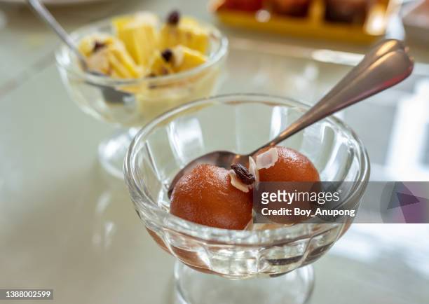 close up of gulab jamun dessert served on table. gulab jamun is a classic indian sweet. - cultura del bangladesh foto e immagini stock