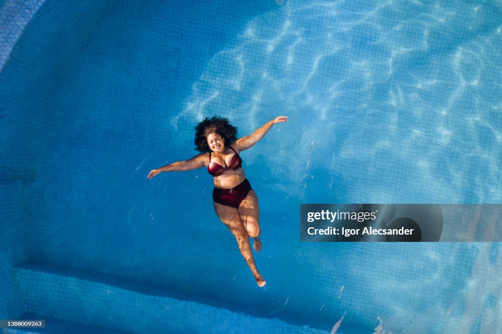 Top view of woman relaxing in swimming poll