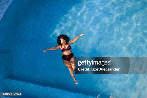 Top view of woman relaxing in swimming poll Top view of woman relaxing in swimming poll