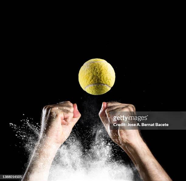 hands of a tennis player catching a ball. - ballon rebond stock-fotos und bilder