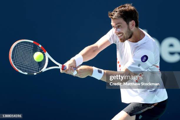 Cameron Norrie of Great Britain returns a shot to Hugo Gaston of France during the Miami Open at Hard Rock Stadium on March 27, 2022 in Miami...