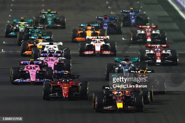 Sergio Perez of Mexico driving the Oracle Red Bull Racing RB18 leads Charles Leclerc of Monaco driving the Ferrari F1-75 and the rest of the field...