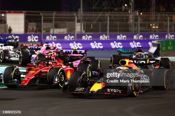 Max Verstappen of the Netherlands driving the Oracle Red Bull Racing RB18 and Carlos Sainz of Spain driving the Ferrari F1-75 battle for track...