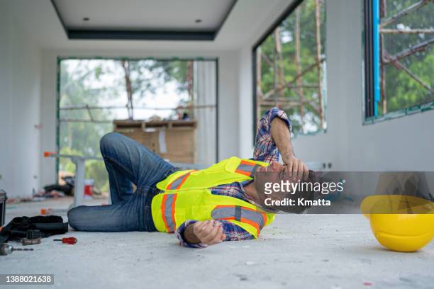 an accident of a construction worker at the construction site. - building site accidents imagens e fotografias de stock
