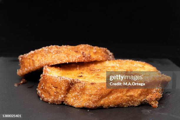 still life- torrijas - a typical spring dessert in spain: bread soaked in flavored milk, coated in egg and fried. - deep fried stock pictures, royalty-free photos & images