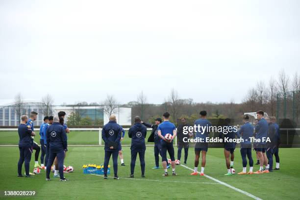 Steve Holland, Assistant Manager of England talks to players during a training session at Tottenham Hotspur Training Centre on March 27, 2022 in...