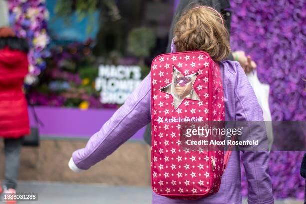 Girl wearing an "American Girl" doll and backpack visits the 2022 Macy's Flower Show at Macy's Herald Square on March 27, 2022 in New York City. This...