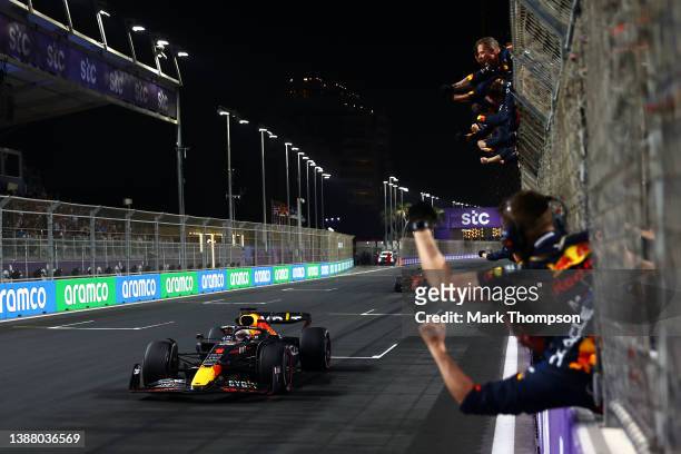 Race winner Max Verstappen of the Netherlands driving the Oracle Red Bull Racing RB18 passes his team celebrating on the pitwall during the F1 Grand...
