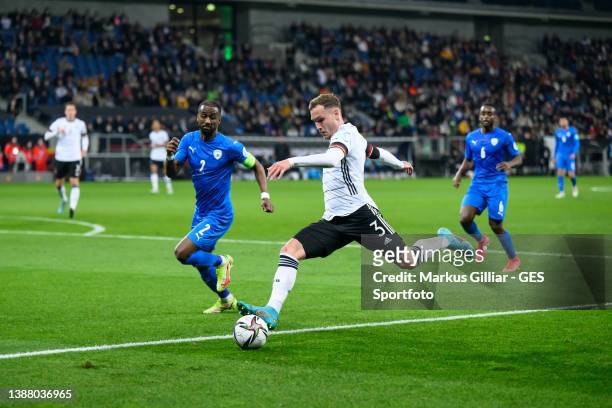David Raum of Germany in action with Eli Dasa of Israel during the international friendly match between Germany and Israel at PreZero-Arena on March...