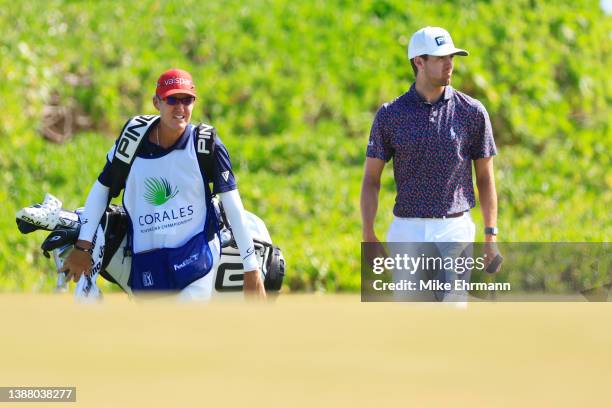 Alex Smalley of the United States walks with his caddie Don Donatello on the 17th hole during the final round of the Corales Puntacana Championship...