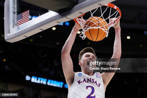 Christian Braun of the Kansas Jayhawks dunks the ball against the Miami Hurricanes during the second half in the Elite Eight round game of the 2022...