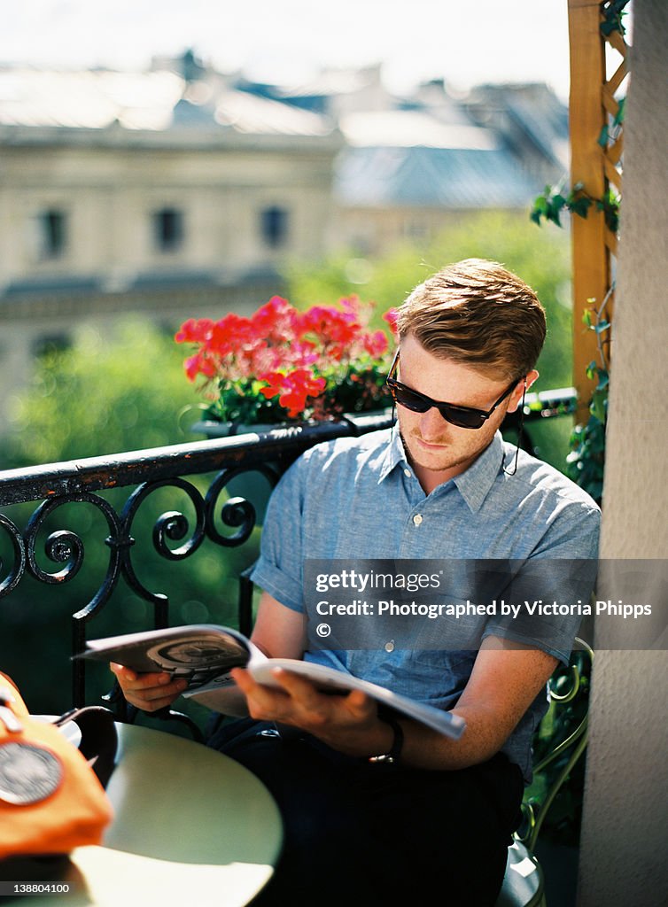 Young man reading magazine