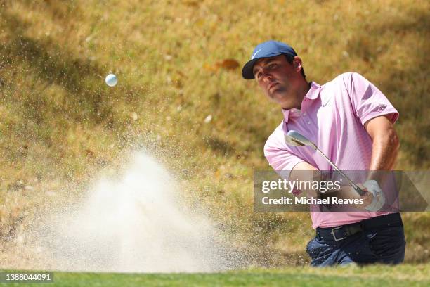 Scottie Scheffler of the United States plays a shot from a bunker on the fifth hole in his finals match against Kevin Kisner of the United States on...