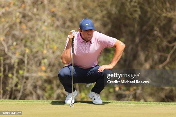 Scottie Scheffler of the United States looks over a putt on the first green in his finals match against Kevin Kisner of the United States on the...