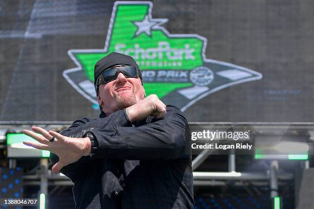 Professional wrestler The Undertaker walks onstage during pre-race ceremonies prior to the NASCAR Cup Series Echopark Automotive Grand Prix at...