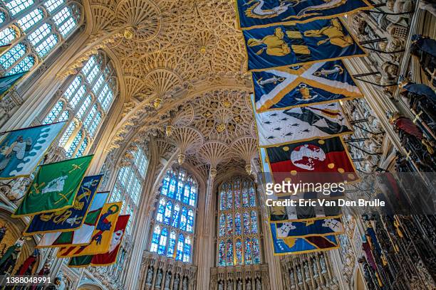 westminster abbey ornate ceiling with rows of flags - eric van den brulle stock pictures, royalty-free photos & images