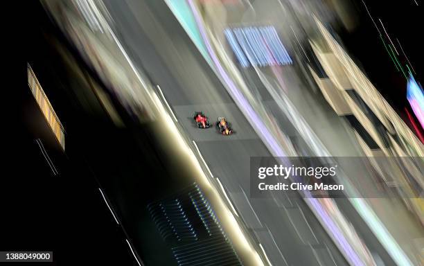 Max Verstappen of the Netherlands driving the Oracle Red Bull Racing RB18 and Charles Leclerc of Monaco driving the Ferrari F1-75 battle for track...