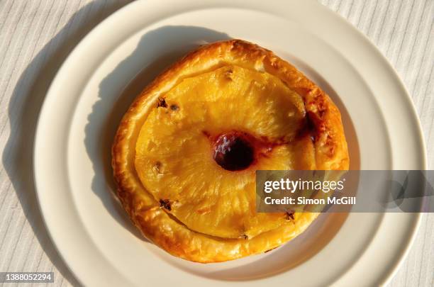 individual pineapple tart tartin on a round white plate - tarte tatin stock-fotos und bilder