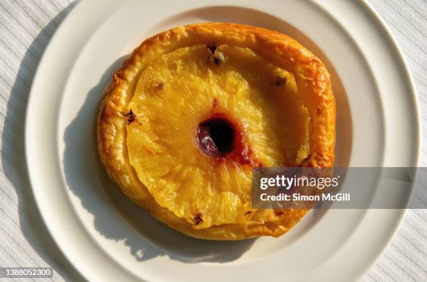 individual pineapple tart tartin on a round white plate - tarte tartin stock pictures, royalty-free photos & images