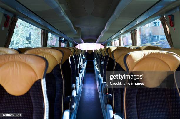 inside a bus, empty seats after passengers arrive at the destination after their road trip. - interior del vehículo fotografías e imágenes de stock