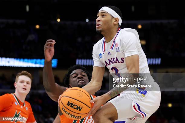 Dajuan Harris Jr. #3 of the Kansas Jayhawks drives to the basket against Bensley Joseph of the Miami Hurricanes during the second half in the Elite...