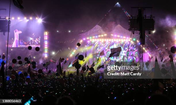 The main Pyramid stage is illuminated during a performance by Coldplay during the 2016 Glastonbury Festival held at Worthy Farm, in Pilton near...