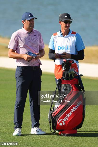 Scottie Scheffler of the United States talks with his caddie Ted Scott on the 14th hole in his finals match against \kkon the final day of the World...