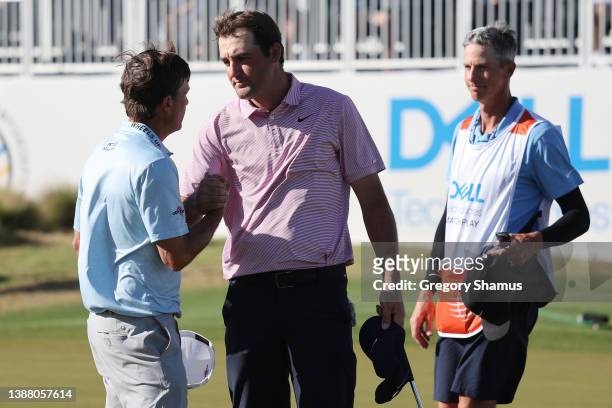 Scottie Scheffler of the United States shakes hands with Kevin Kisner of the United States on the 15th green after defeating him 4&3 to in their...