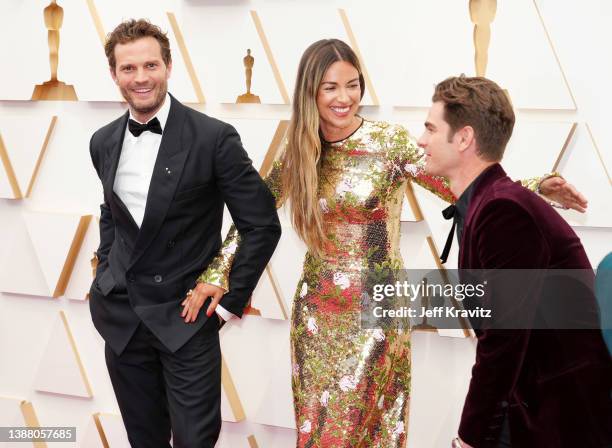 Jamie Dornan, Amelia Warner, and Andrew Garfield attend the 94th Annual Academy Awards at Hollywood and Highland on March 27, 2022 in Hollywood,...