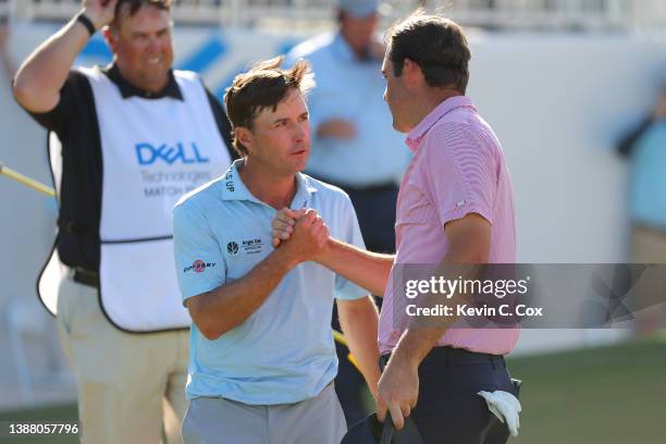 Scottie Scheffler of the United States shakes hands with Kevin Kisner of the United States on the 15th green after defeating him 4&3 to in their...