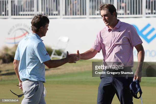Scottie Scheffler of the United States shakes hands with Kevin Kisner of the United States on the 15th green after defeating him 4&3 to in their...