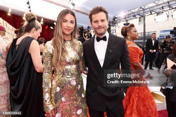 Amelia Warner and Jamie Dornan attend the 94th Annual Academy Awards at Hollywood and Highland on March 27, 2022 in Hollywood, California.