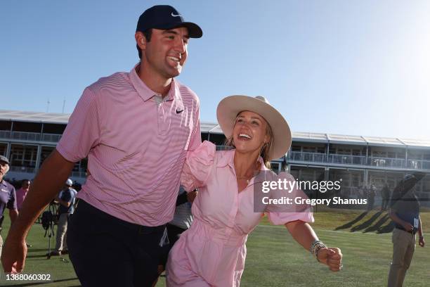 Scottie Scheffler of the United States celebrates with his wife Meredith Scheffler on the 15th green after defeating Kevin Kisner of the United...