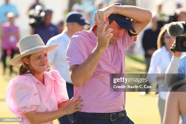 Scottie Scheffler of the United States celebrates with his wife Meredith Scheffler on the 15th green after defeating Kevin Kisner of the United...