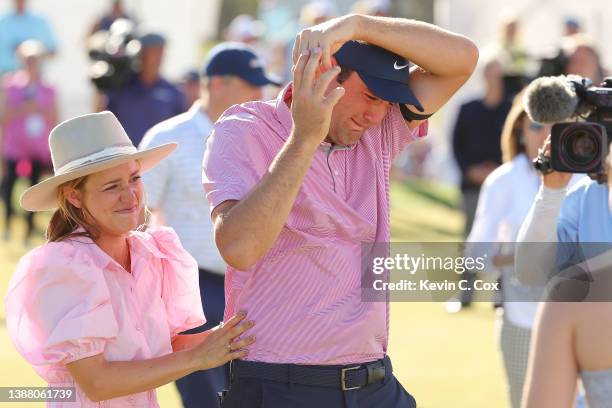 Scottie Scheffler of the United States celebrates with his wife Meredith Scheffler on the 15th green after defeating Kevin Kisner of the United...