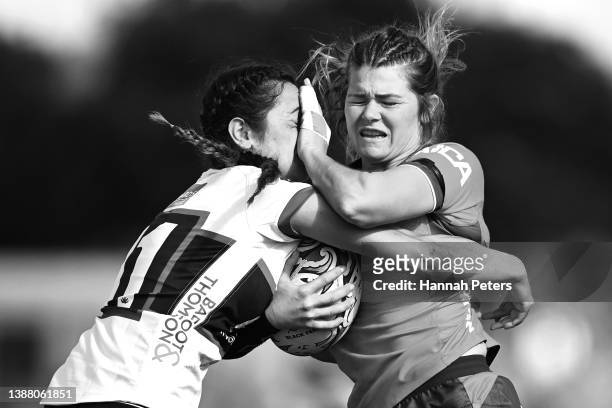 Tamara Silcock of Tasman fends off Moana Courtenay of North Harbour during the round two Farah Palmer Cup match between North Harbour and Tasman at...