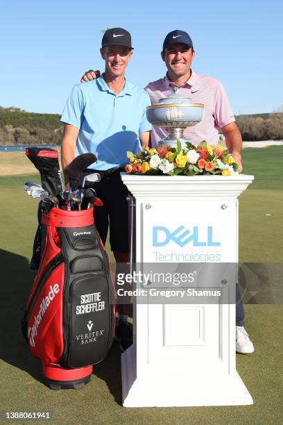 Scottie Scheffler of the United States poses with his caddie Ted Scott and the Walter Hagen Cup after defeating Kevin Kisner of the United States 4&3...