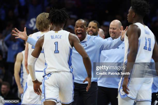 Head coach Hubert Davis of the North Carolina Tar Heels celebrates with Leaky Black after defeating the St. Peter's Peacocks 69-49 in the Elite Eight...