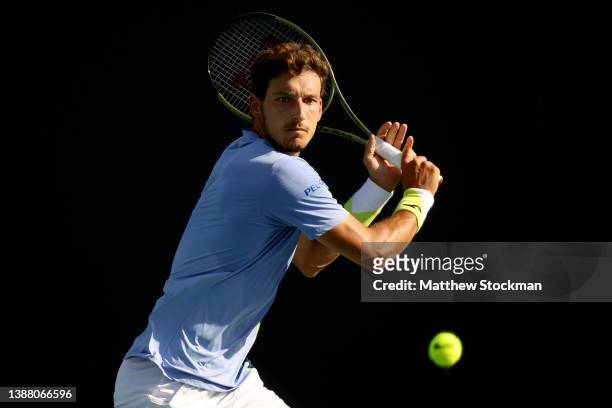 Pablo Carreno Busta of Spain returns a shot to Jannik Sinner of Italy during the Miami Open at Hard Rock Stadium on March 27, 2022 in Miami Gardens,...