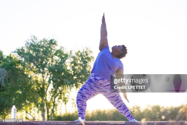 active lifestyle - warrior 1 pose stock pictures, royalty-free photos & images