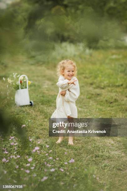 cute girl walking in the park in romantic dress and wicker basket with flowers. - girl dress romantic stock-fotos und bilder