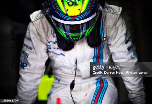 Brazilian Williams Formula One racing team racing driver Felipe Massa in the team's pit lane, pit garage, wearing his logo adorned fire protection...