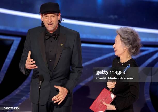 Troy Kotsur accepts the Actor in a Supporting Role award for ‘CODA’ from Youn Yuh-jung onstage during the 94th Annual Academy Awards at Dolby Theatre...