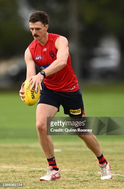 Jake Lever of the Demons kicks during a Melbourne Demons AFL training session at Gosch's Paddock on March 28, 2022 in Melbourne, Australia.